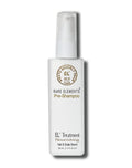 A luxury hair and scalp treatment in a white bottle with a treatment pump dispenser labeled 'RARE ELEMENTS Pre-Shampoo Hair & Scalp Serum', with gold  text.