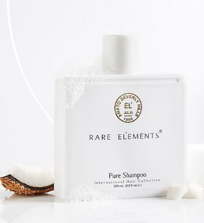 Rare Elements Pure Shampoo bottle with packaging on a white background and suds.